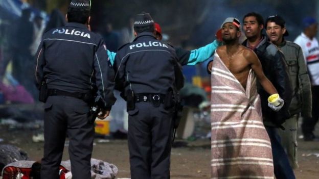 Drug users talk with police officers during a police operation in Cracolandia (Crackland), in downtown Sao Paulo, Brazil June 11, 2017.