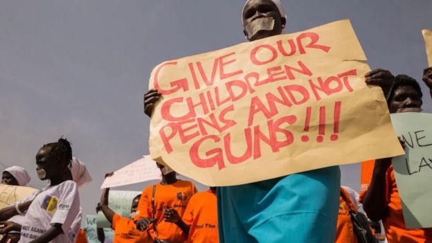South Sudan protester holding a placard