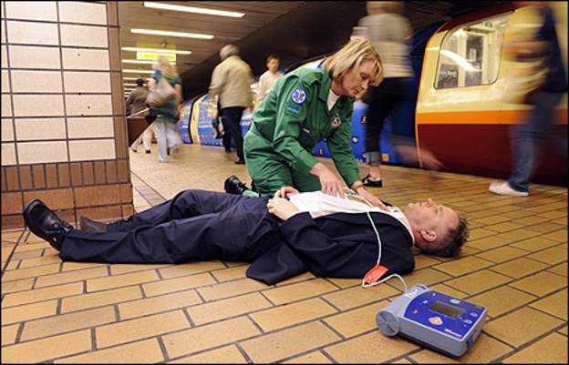 Paramedic using defibrillator