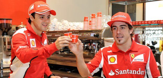 Felipe Massa and Fernando Alonso serve coffee to Australian fans