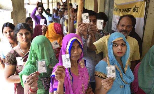 Voters queue outside a polling booth during the first phase of voting in India.