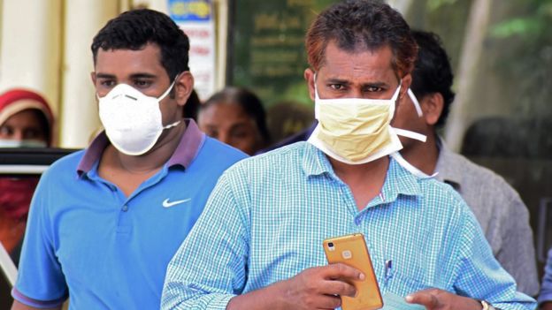 Two Indian men wear face masks