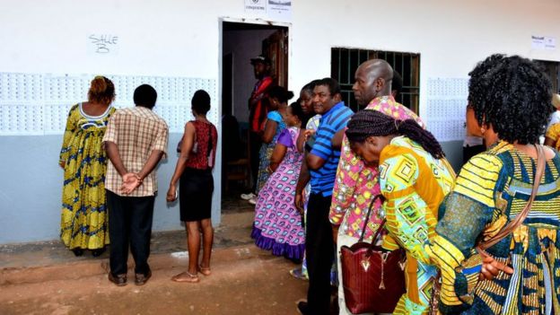 People wait in line to cast their votes at a polling station during presidential elections in Yaounde, Cameroon on October 07, 2018.