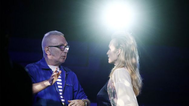 Jean-Paul Gaultier speaking with French model Estelle Lefebure