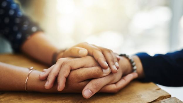 Two people holding hands