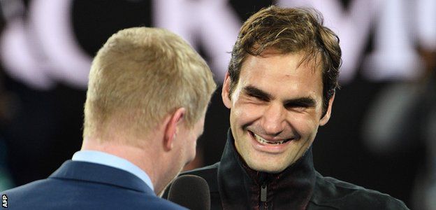 Roger Federer shares a joke with Jim Courier following his victory