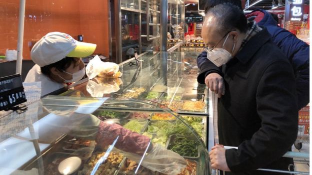 People in face masks in a supermarket in Beijing, China