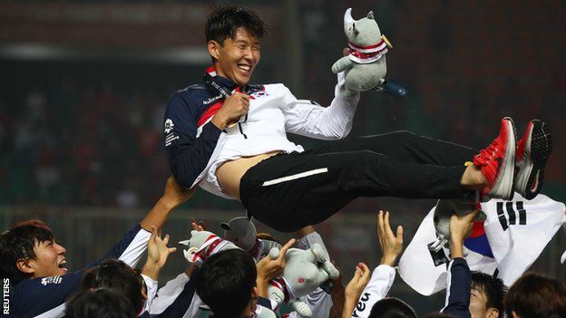 Son Heung-min of South Korea is held aloft by his team-mates after winning the gold medal