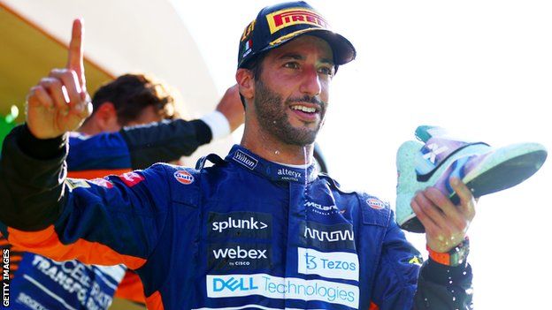 Daniel Ricciardo does a shoey on the podium at Monza