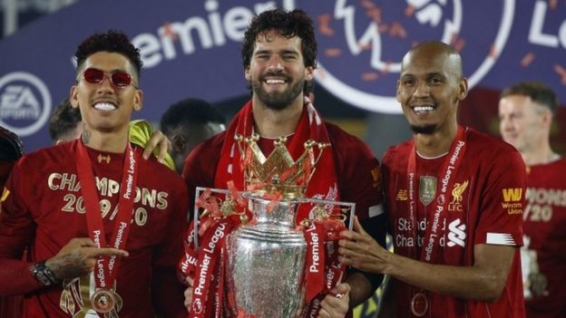 Liverpool's Roberto Firmino, Alisson and Fabinho celebrate with the Premier League trophy