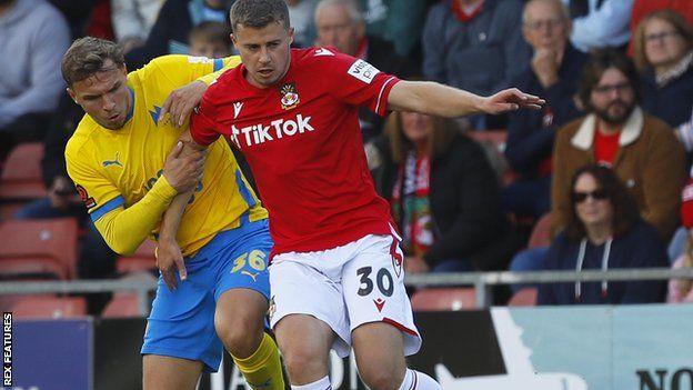 Wrexham's James Jones battles for the ball with Torquay's Scott Smith