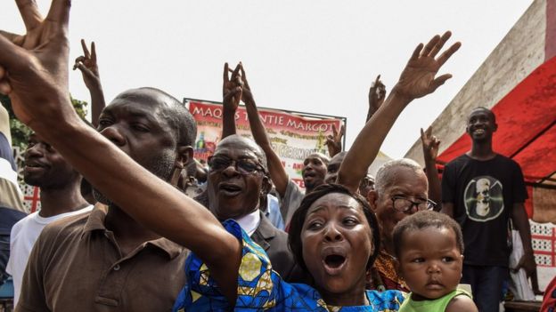People in Abidjan celebrate after hearing of Mr Gbagbo's acquittal