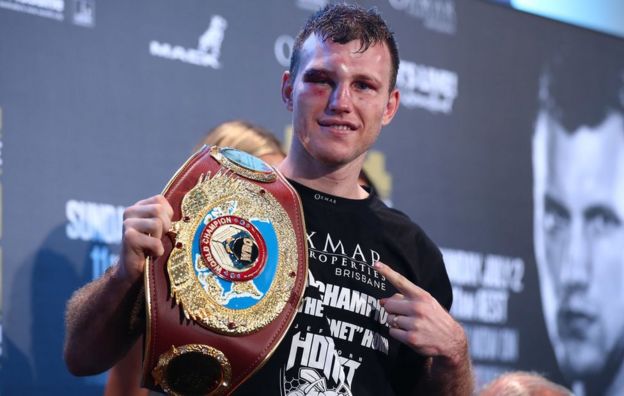 Jeff Horn points to a belt saying 'world champion' following the bout