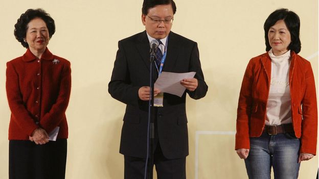 Leading pro democrat Anson Chan (L) and election rival Regina Ip (R) listen to a returning officer in Hong Kong 03 December 2007