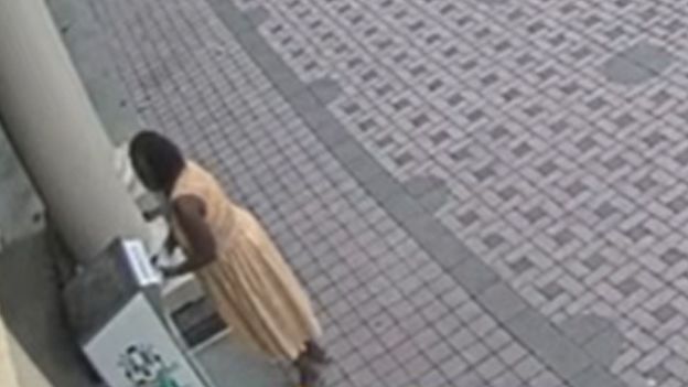 Screenshot of CCTV footage showing a person putting ballots into a drop box
