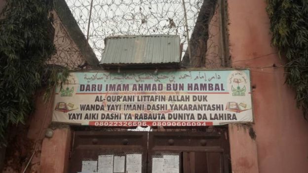 A sign in the Hausa language outside the school reads: "Ahmad bin Hambal Centre for Islamic teachings. The Koran is the book of Allah, whoever believes in it, reads it and adopt sit will have salvation in this life and in the hereafter."