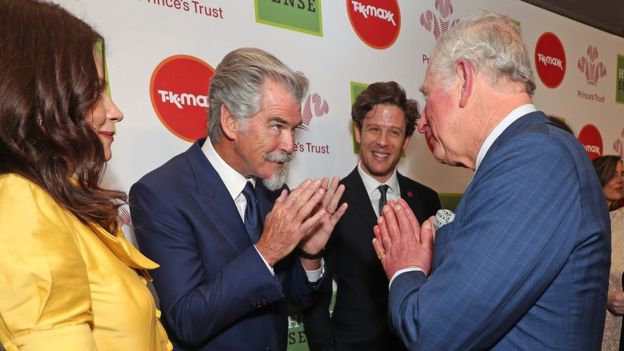 Prince of Wales greeting Pierce Brosnan (centre) with a Namaste gesture as he arrives at the annual Prince"s Trust Awards 2020 held at the London Palladium