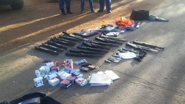 Seized guns laid out on the road by police
