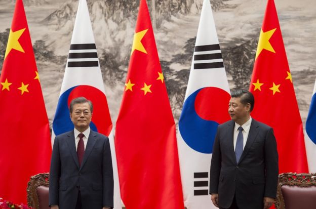 South Korean President Moon Jae-In (L) and Chinese President Xi Jinping (R) stand together at the end of a signing ceremony at the Great Hall of the People on December 14, 2017 in Beijing, China. (Photo by Nicolas Asfouri-Pool/Getty Images)
