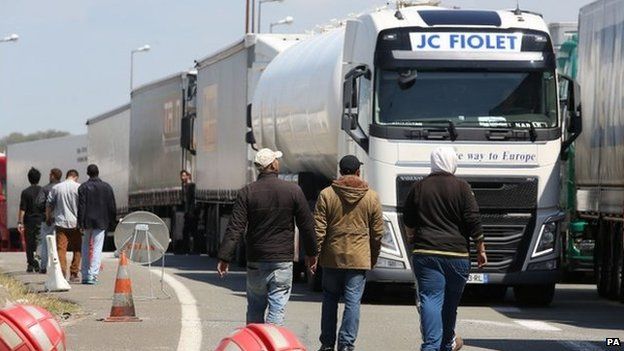Migrants surrounding lorries outside Calais