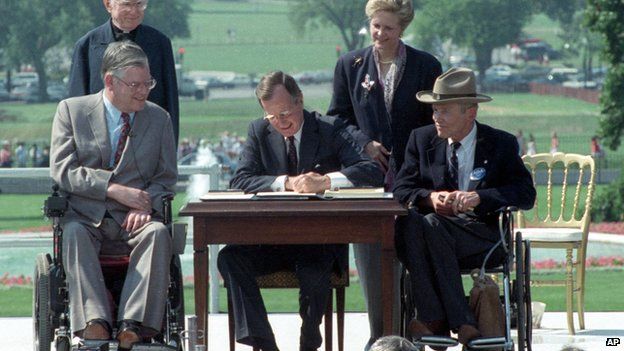 President George HW Bush signing the Americans with Disabilities Act into law in 1990