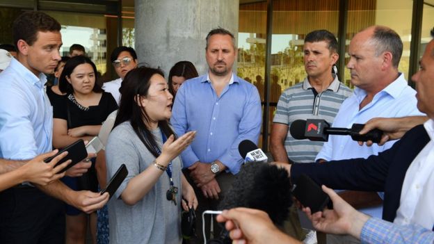 Resident questions Icon director outside the Opal Tower