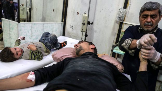 A man and a child injured by government bombardment in rebel-held Douma, Syria, receive medical attention at a field hospital (27 November 2017)