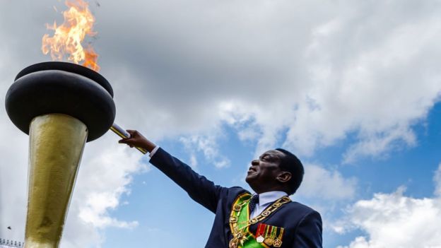 Zimbabwe's President Emmerson Mnangagwa lights the Eternal Flame of Freedom during Zimbabwe Independence Day celebrations at the National Sports Stadium on April 18, 2018 in Harare.