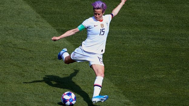 Megan Rapinoe kicking a ball