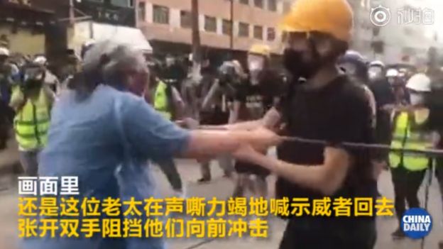 An altercation between an elderly woman and protesters