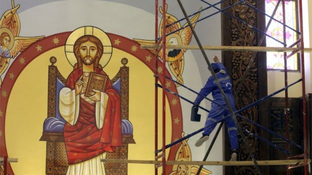 A worker helps finish the new Cathedral of Nativity outside Cairo in Egypt