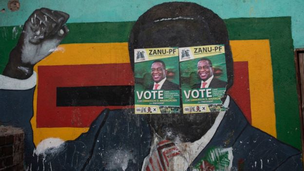 A mural of Robert Mugabe at a Zanu-PF office in Harare, Zimbabwe, with the face covered in two Zanu-PF election posters