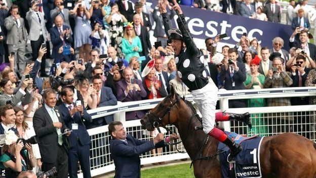 Frankie Dettori performs a flying dismount after winning the Oaks at Epsom