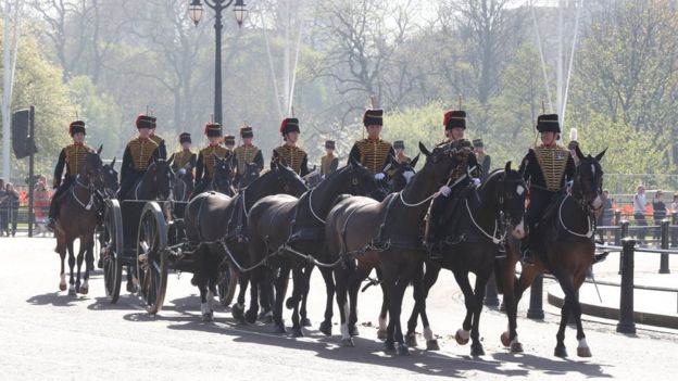 Members of the Kings Troop Royal Horse Artillery ride out in front of Buckingham Palace en route to Green Park
