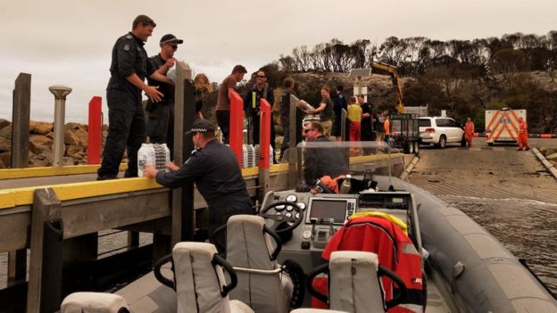 Police unloading water in Mallacoota from one of their smaller vessels