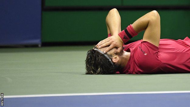 Dominic Thiem lying on court after winning the US Open title