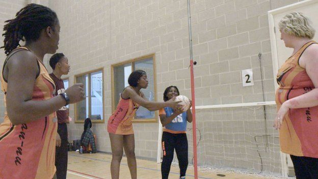 Bran Nu netball player Nikita helps a young club member with her shooting skills