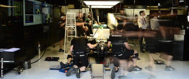 Mechanics working on Lewis Hamilton's car