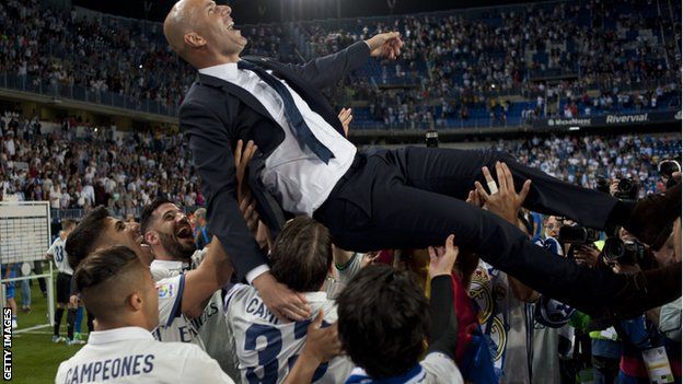 Zinedine Zidane is lifted into the air as Real Madrid celebrate winning La Liga on Sunday