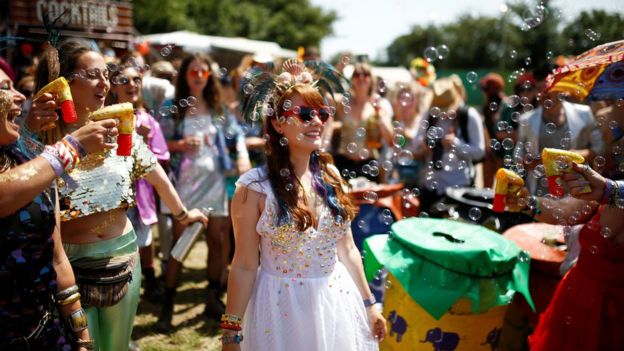 Festival-goers spray bubbles at Glastonbury