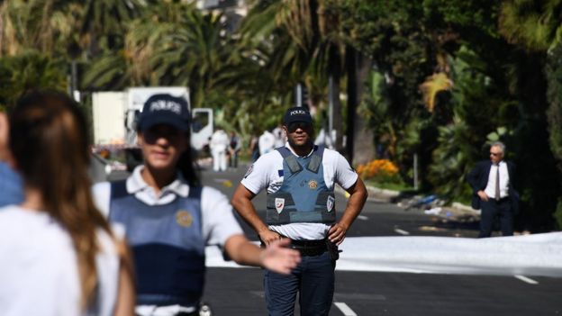 Policemen stand guard the Promenade des Anglais seafront in the French Riviera town of Nice on 15 July 2016