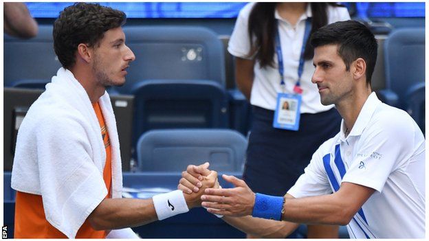 Novak Djokovic shakes hands with Pablo Carreno Busta after US Open default