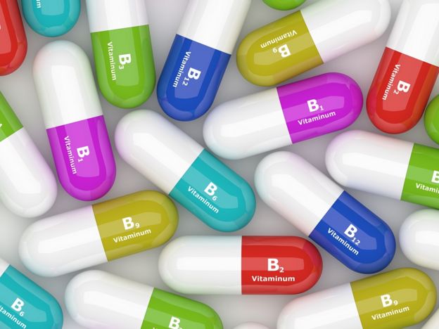 3D vitamin B capsules lying on a white table