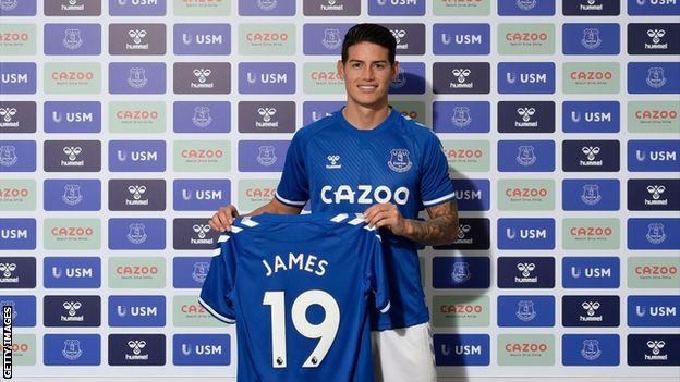 James Rodriguez holds up an Everton shirt