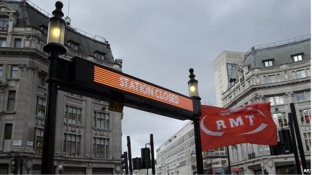 An RMT flag flies at the closed Tube station entrance at Oxford Circus