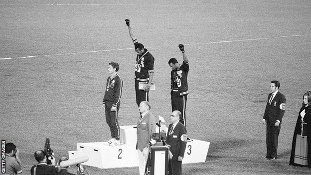 Tommie Smith and John Carlos raise their fist in a Black Power salute on the podium at the Olympics