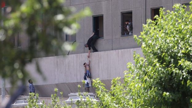 Iranian policemen try to help some civilians fleeing from the parliament building during an attack in Tehran, Iran, 07 June 2017