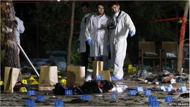 Forensic and police officers work at the site of a bomb attack on July 20, 2015 in Suruc, Turkey.