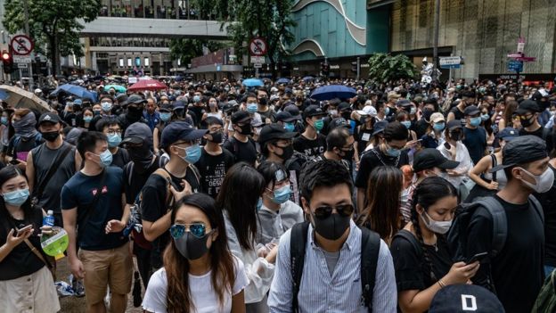 Protesters take part in an anti-government rally as they march on a street in Central district