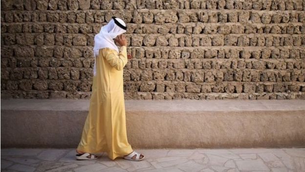 مواطن خليجي يمسك هاتفه
